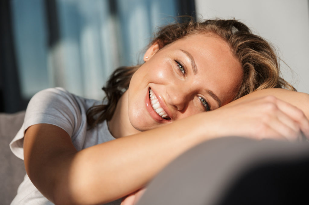 Smiling young woman after acne treatments