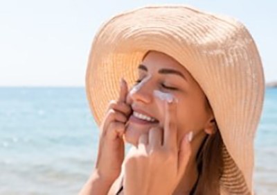 woman applying sun lotion