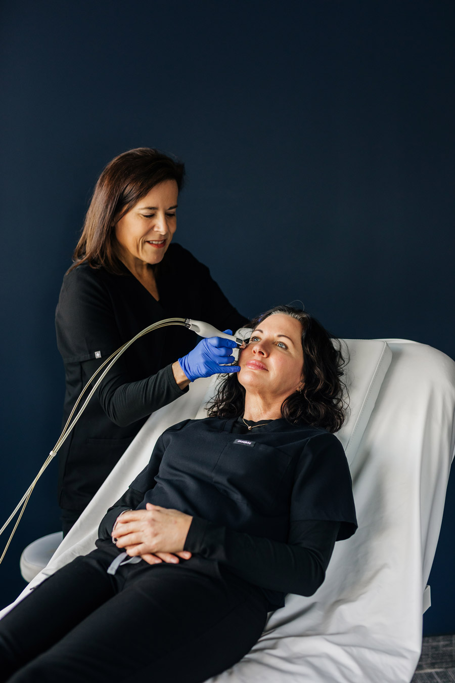 Julie Davis, founder of Renew MedSpa, performing a facial treatment on a client in Eagan, MN